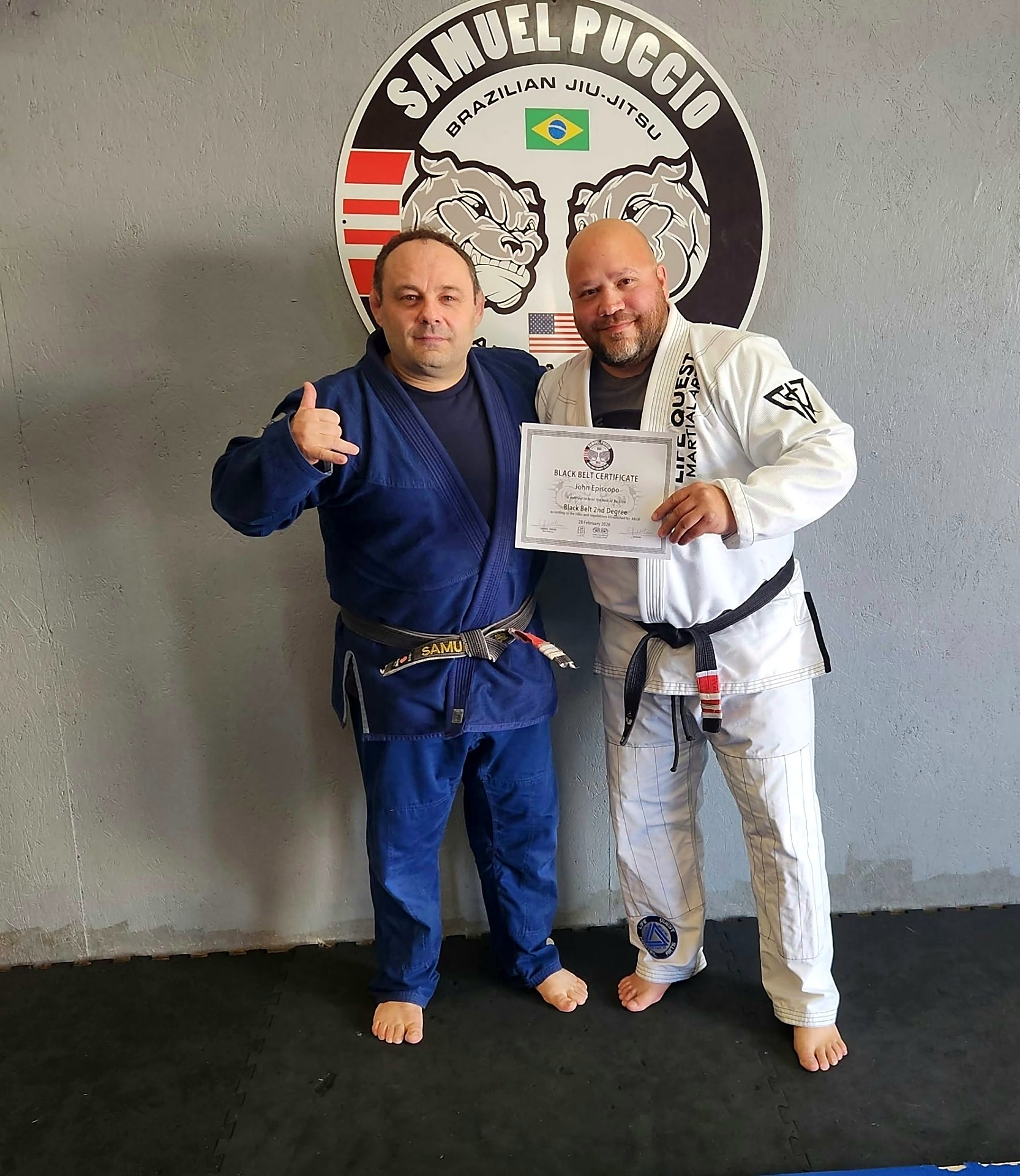 Coach John Episcopo receiving his 2nd degree black belt certificate